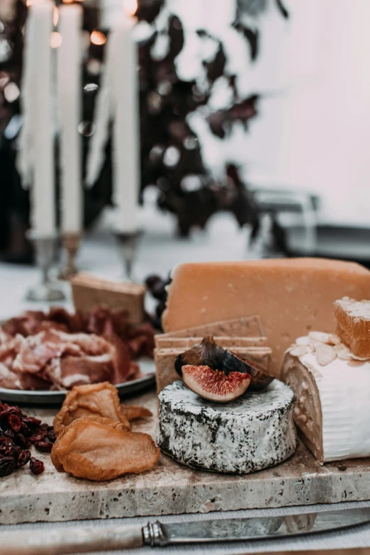 a table topped with lots of different types of cheese, pexels contest winner, renaissance, black and auburn colour pallet, romantic, foil, bakery