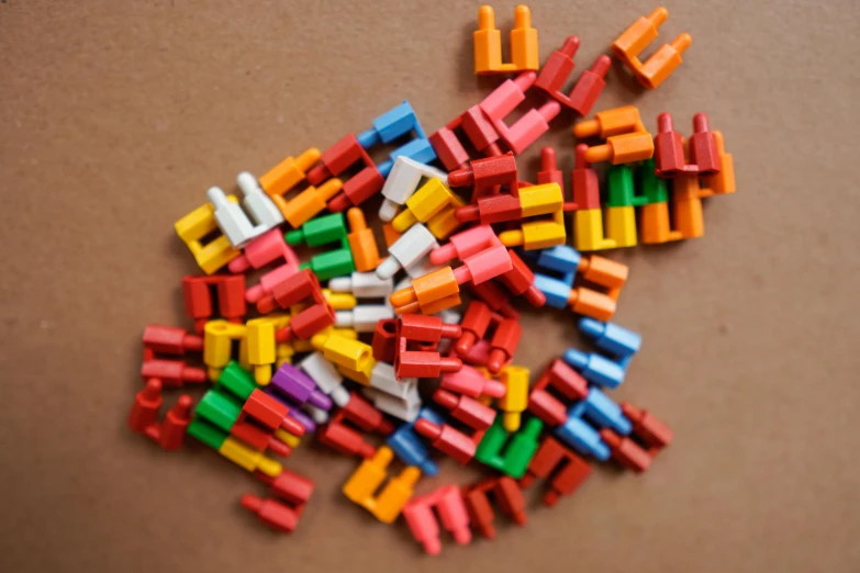 a pile of legos sitting on top of a table, colorful pigtail, pinned joints, warm coloured, repetition