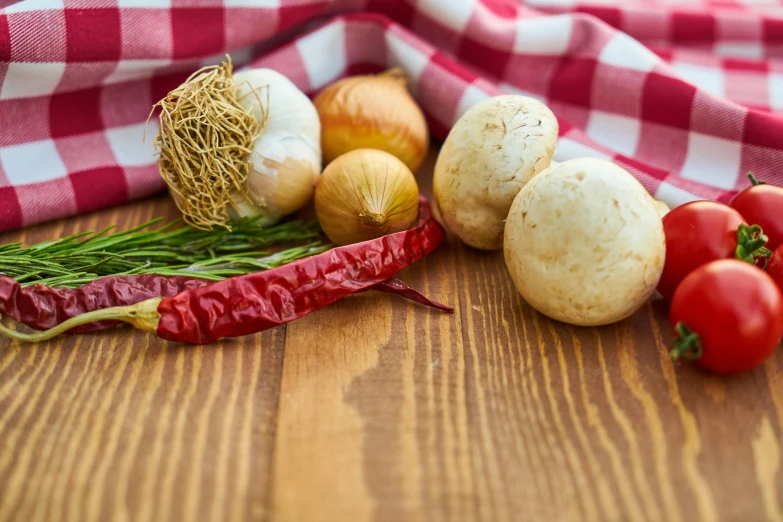 a bunch of vegetables sitting on top of a wooden table, inspired by Géza Dósa, unsplash, square, made of mushrooms, spices, fabrics and textiles