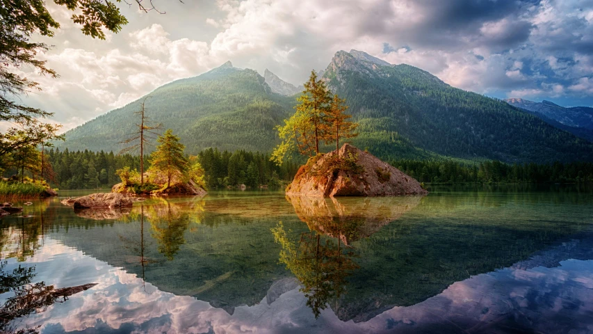 a body of water surrounded by trees and mountains, a matte painting, by Sebastian Spreng, pexels contest winner, dynamic reflections, floating islands, colorful photograph, stunning screensaver