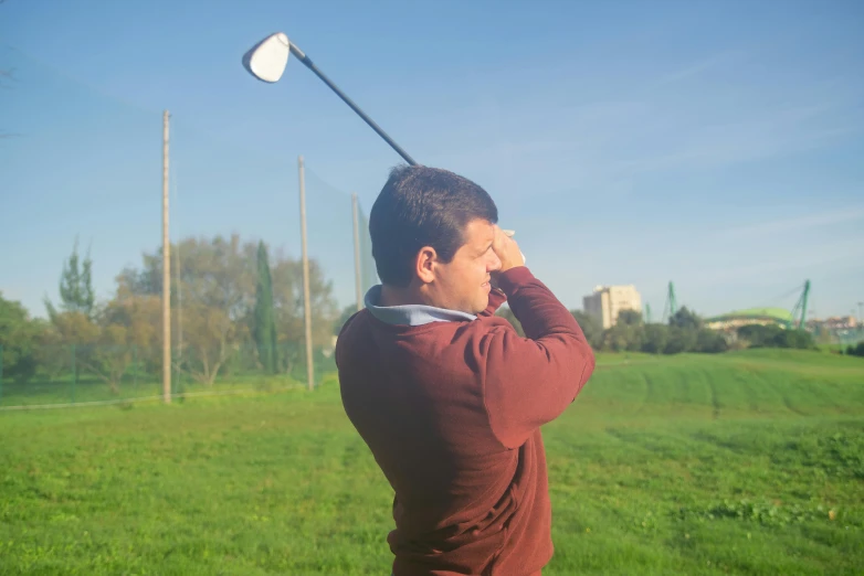 a man that is standing in the grass with a golf club, in the sun, rectangle, camilo gc, head is up