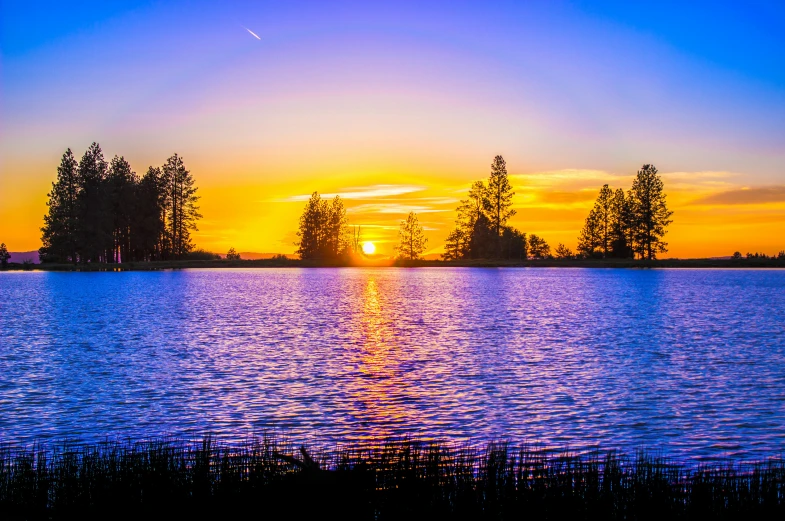 the sun is setting over a large body of water, unsplash, sydney park, highly saturated, gold coast australia, central california