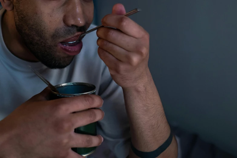 a close up of a person eating food with a spoon, hurufiyya, deep in thought, someone sits in bed, the straw is in his mouth, chilly dark mood