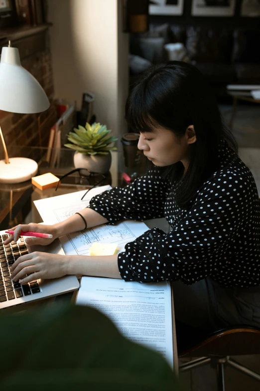 a woman sitting at a desk using a laptop computer, inspired by Li Di, pexels contest winner, academic art, asian descent, high angle shot, multiple lights, profile image