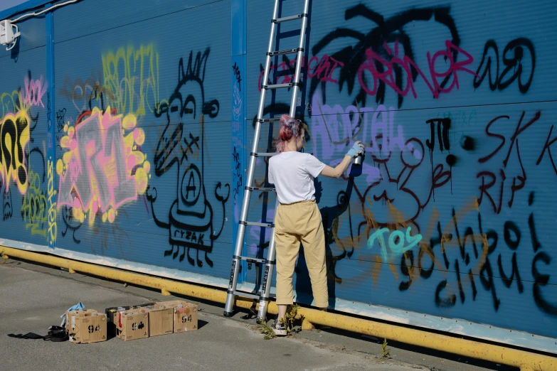 a man is painting graffiti on the side of a building, avatar image, woman in streetwear, thumbnail, cgsocciety r/art