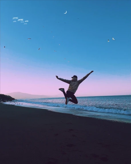 a man jumping into the air on a beach, a picture, happening, ✨🕌🌙, lgbtq, she is in pure bliss, trending on vsco