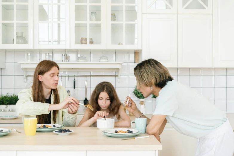 a group of people sitting around a kitchen table, with a kid, minimal kitchen, profile image, milk