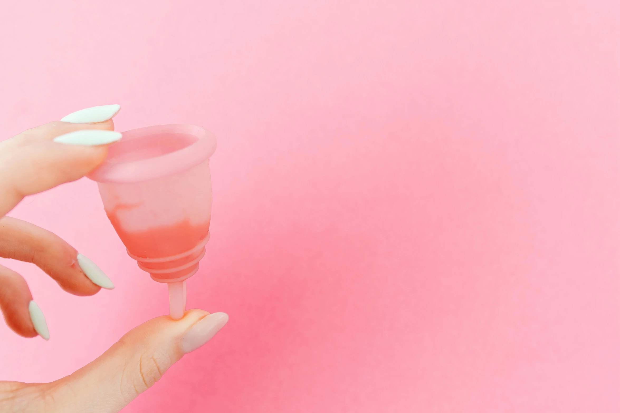 a woman's hand holding a pink cup on a pink background, by Liza Donnelly, trending on unsplash, plasticien, cocktail in an engraved glass, bubblegum pop, ivy's, 3 d print