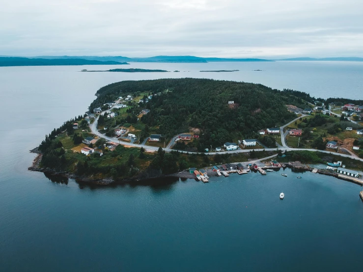 a small island in the middle of a body of water, by Jesper Knudsen, pexels contest winner, small port village, hestiasula head, wide high angle view, high light on the left