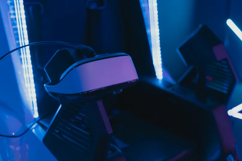a pair of vr glasses sitting on top of a desk, a hologram, unsplash, blue accent lighting, in a spaceship cockpit, avatar image