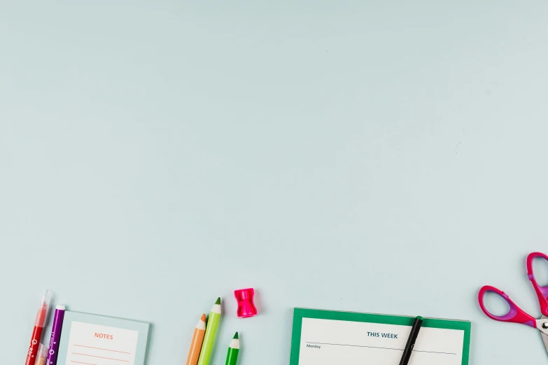 a variety of office supplies laid out on a table, a child's drawing, trending on pexels, postminimalism, cyan and green, background image, wes anderson background, classroom background