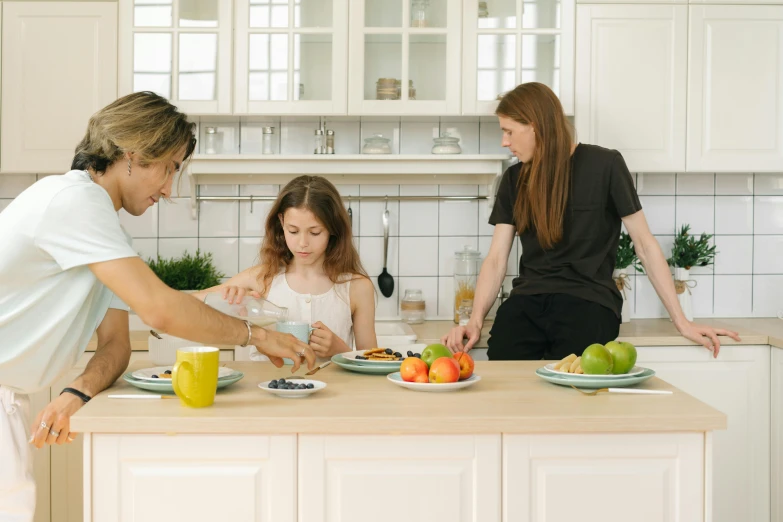 a woman and two children preparing food in a kitchen, pexels, fan favorite, avatar image, man, white kitchen table