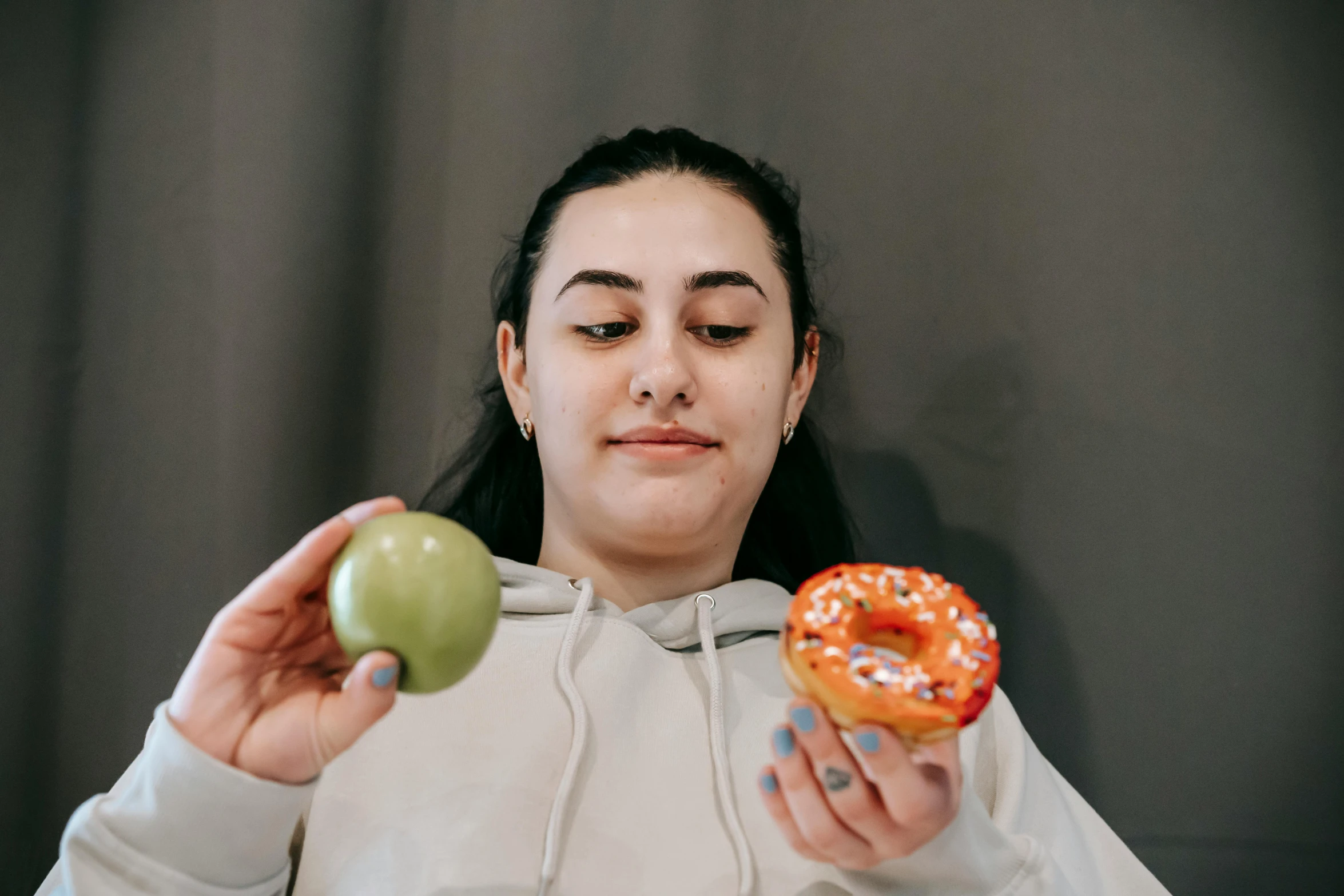 a woman holding an apple and a donut, trending on pexels, hyperrealism, avatar image, 15081959 21121991 01012000 4k