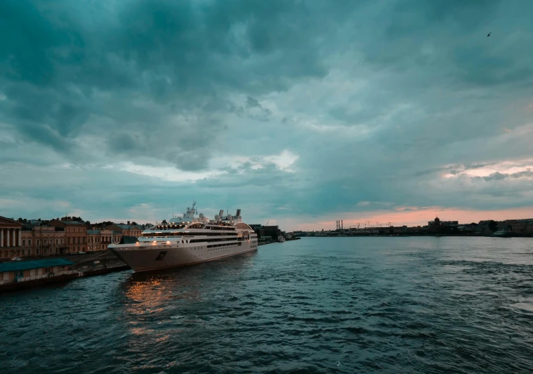 a large boat floating on top of a body of water, by Sebastian Spreng, pexels contest winner, happening, saint petersburg, humid evening, grey cloudy skies, bjarke ingels