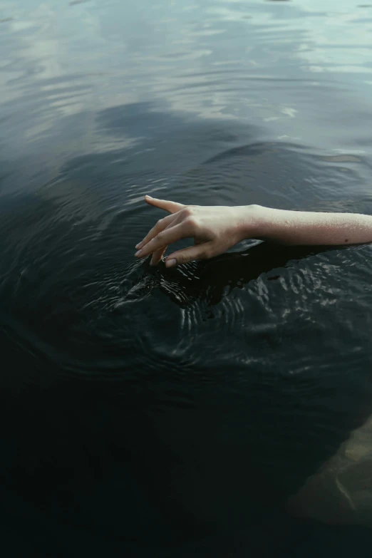 a person swimming in a body of water, an album cover, inspired by Elsa Bleda, pexels contest winner, partially cupping her hands, black water, boat, thirst