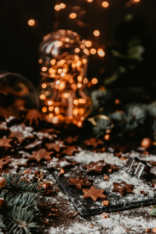 a candle sitting on top of a table covered in snow, by Julia Pishtar, pexels contest winner, cyber copper spiral decorations, chocolate, broken toys are scattered around, hasselblad film bokeh