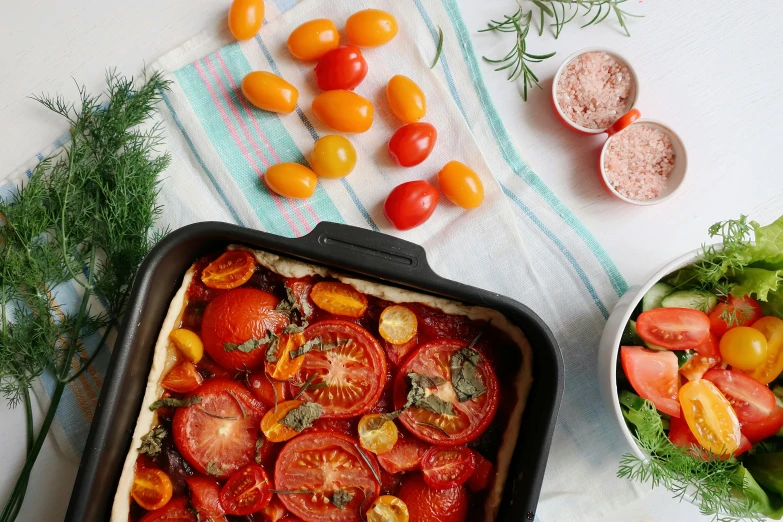 a close up of a pan of food on a table, by Carey Morris, unsplash contest winner, renaissance, also one tomato slice, picnic, white background and fill, conde nast traveler photo