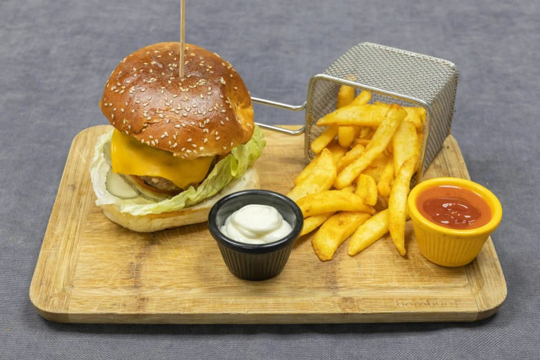 a cheeseburger with fries and ketchup on a cutting board, inspired by Pia Fries, unsplash, hasselblatt, no cropping, detailed product image, restaurant menu photo