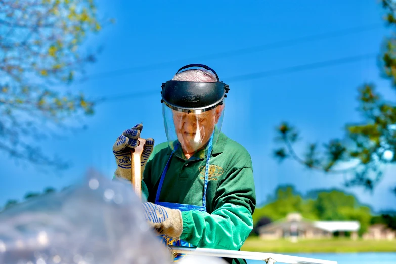 a man that is standing next to a horse, helmet visor smashed, gardening, photo taken with provia, tamborine