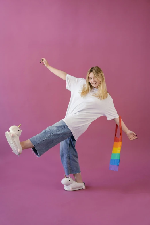 a woman in white shirt doing a trick on a skateboard, by Paul Bird, happening, plush toy, rainbow stripe backdrop, sydney sweeney, wearing a tee shirt and combats