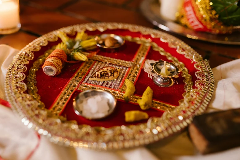 a decorative plate sitting on top of a table, trending on unsplash, hurufiyya, hindu gods, wedding, square, ingredients on the table