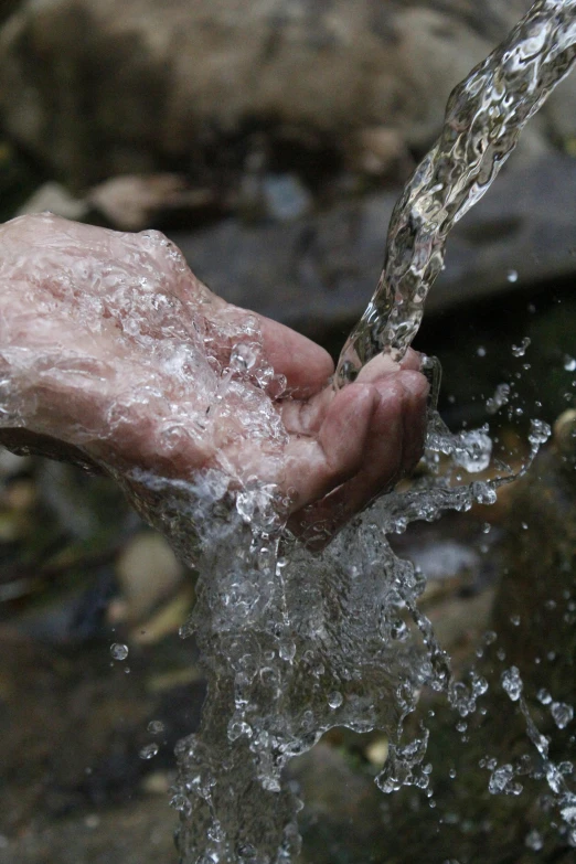 a close up of a person's hand holding a stream of water, slide show, no cropping, drooling, trending photo