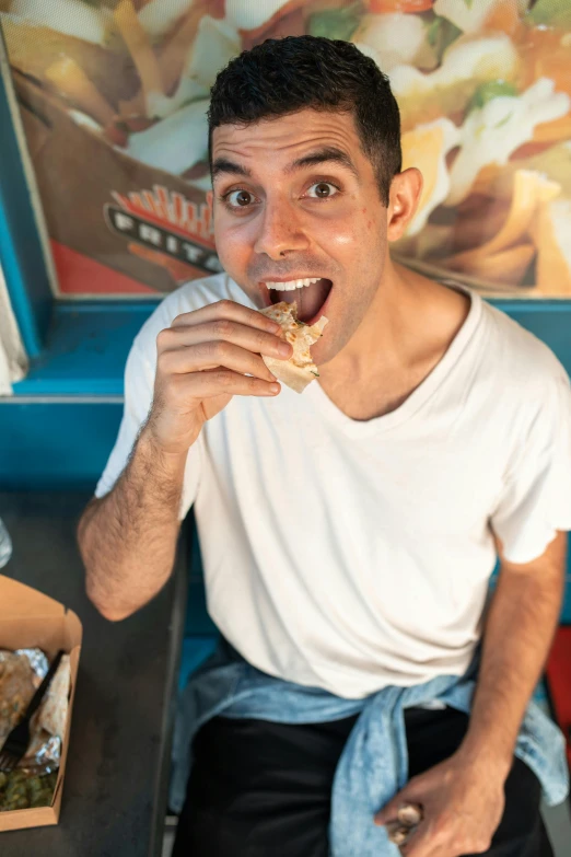 a man sitting at a table eating a sandwich, a portrait, pexels contest winner, ray william johnson, hamburger monster, egypt, beto val