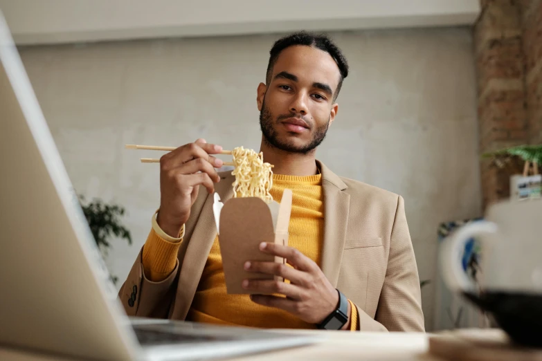 a man eating noodles with chopsticks in front of a laptop, pexels contest winner, wearing business casual dress, avatar image, cardboard, riyahd cassiem