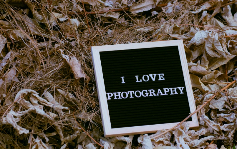 a black and white sign that says i love photography, by Julia Pishtar, art photography, 4k photo”, cardboard, photograph”
