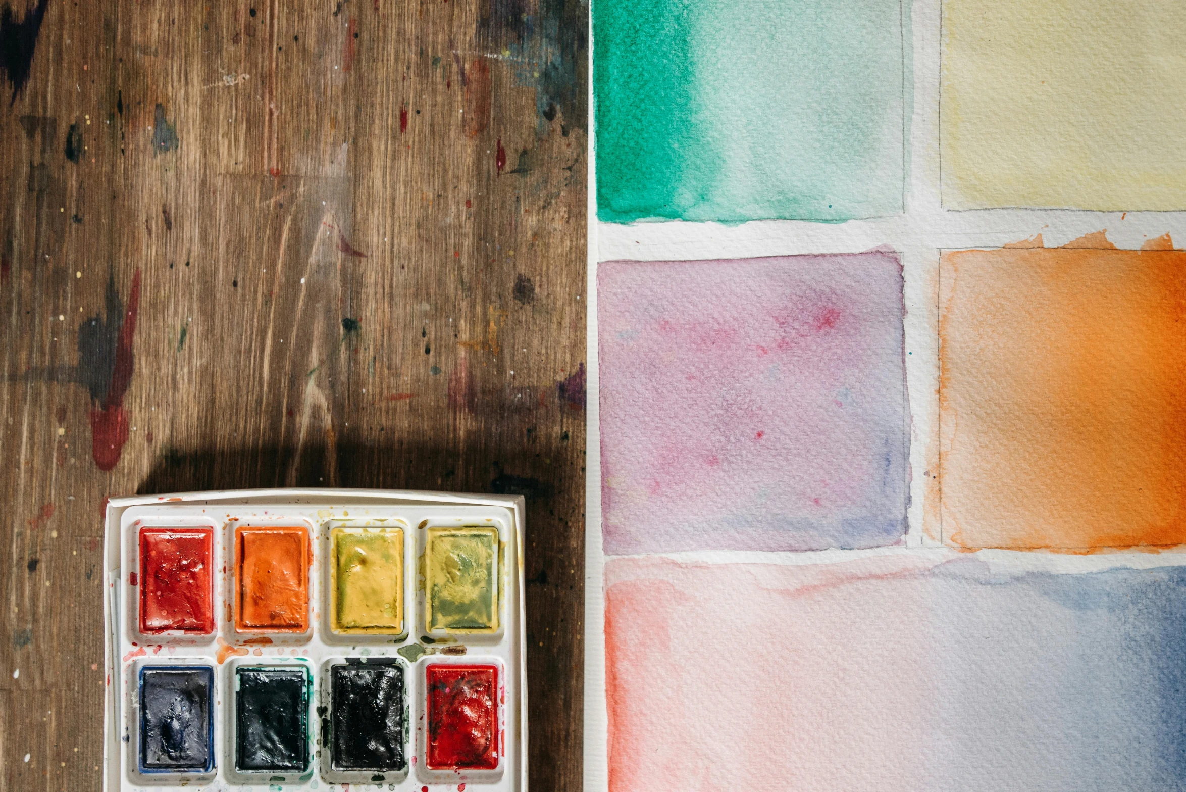 a watercolor palette sitting on top of a wooden table, trending on unsplash, some square paintings, ((water color)), rectangle, unfinished canvas