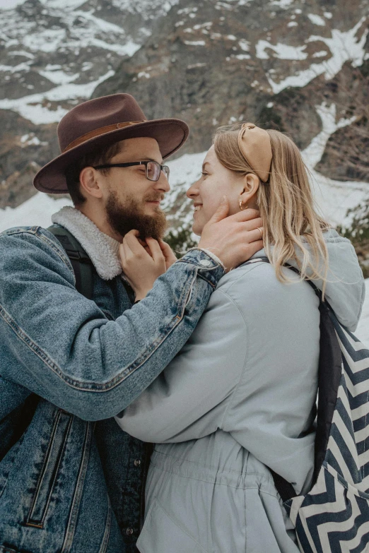 a man and woman standing next to each other in front of a mountain, pexels contest winner, cute details, cold as ice! 🧊, neckbeard, sweet looks