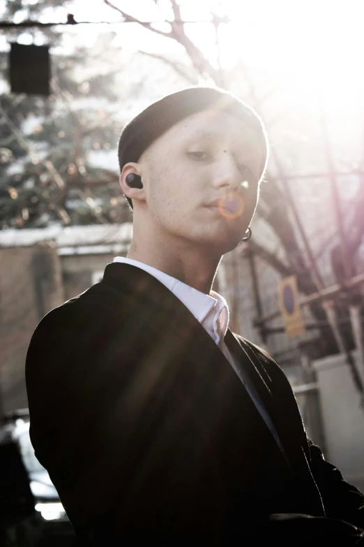 a man in a suit smoking a cigarette, inspired by Oskar Lüthy, unsplash, bauhaus, with head phones, non binary model, singularity sculpted �ー etsy, shaved sides