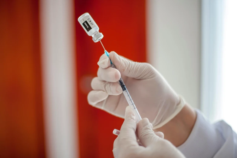 a person in a white lab coat holding a syll, syringe, instagram post, 15081959 21121991 01012000 4k, sleek hands