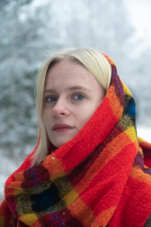a woman wrapped up in a blanket in the snow, an album cover, inspired by Nína Tryggvadóttir, featured on reddit, headshot profile picture, colored photo, vacation photo, square