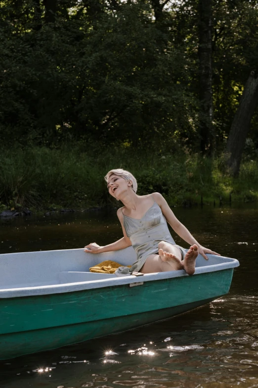 a woman sitting in a small boat in the water, inspired by Anders Zorn, unsplash, conceptual art, milk bath photography, a blond, snacks, in style of joel meyerowitz