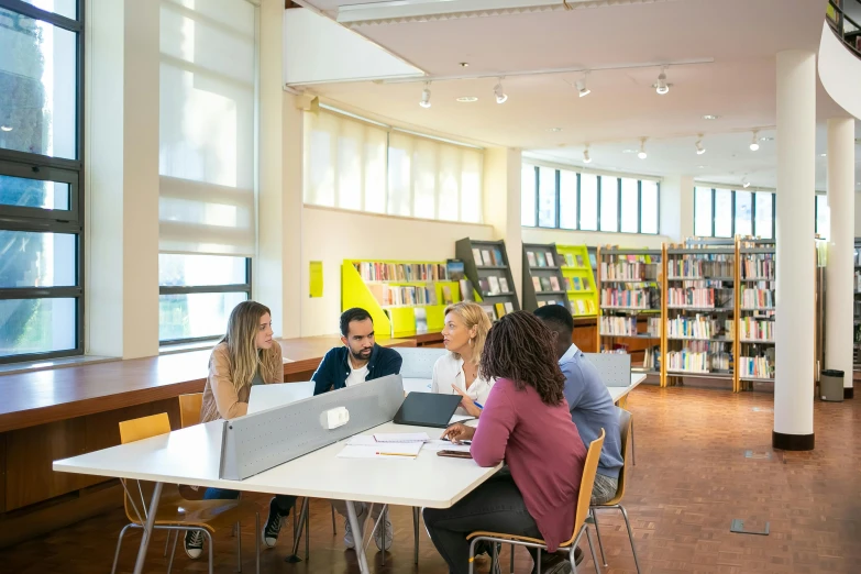 a group of people sitting at a table in a library, studying in a brightly lit room, profile image, digital image, full body image