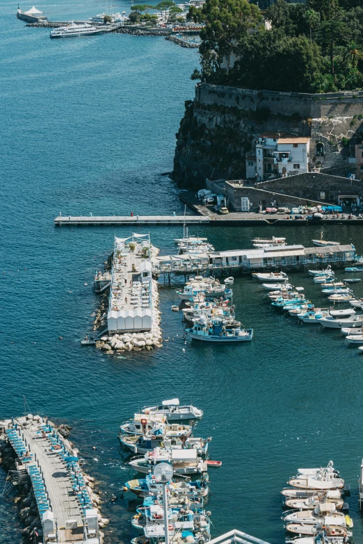 a large body of water filled with lots of boats, by Patrick Pietropoli, pexels contest winner, capri coast, boat dock, low quality photo, color image