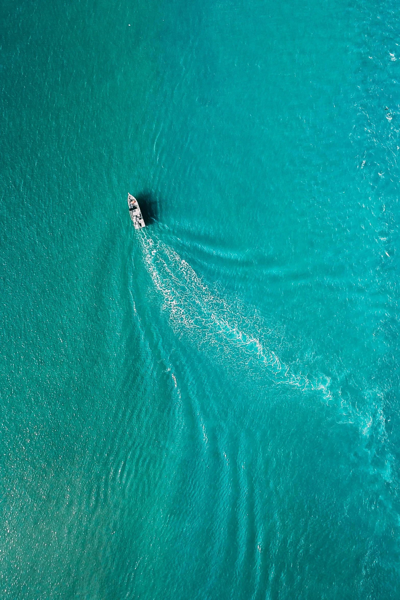 a small boat in the middle of a large body of water, pexels contest winner, looking down from above, gold coast australia, imax photography 4 k, teal color graded