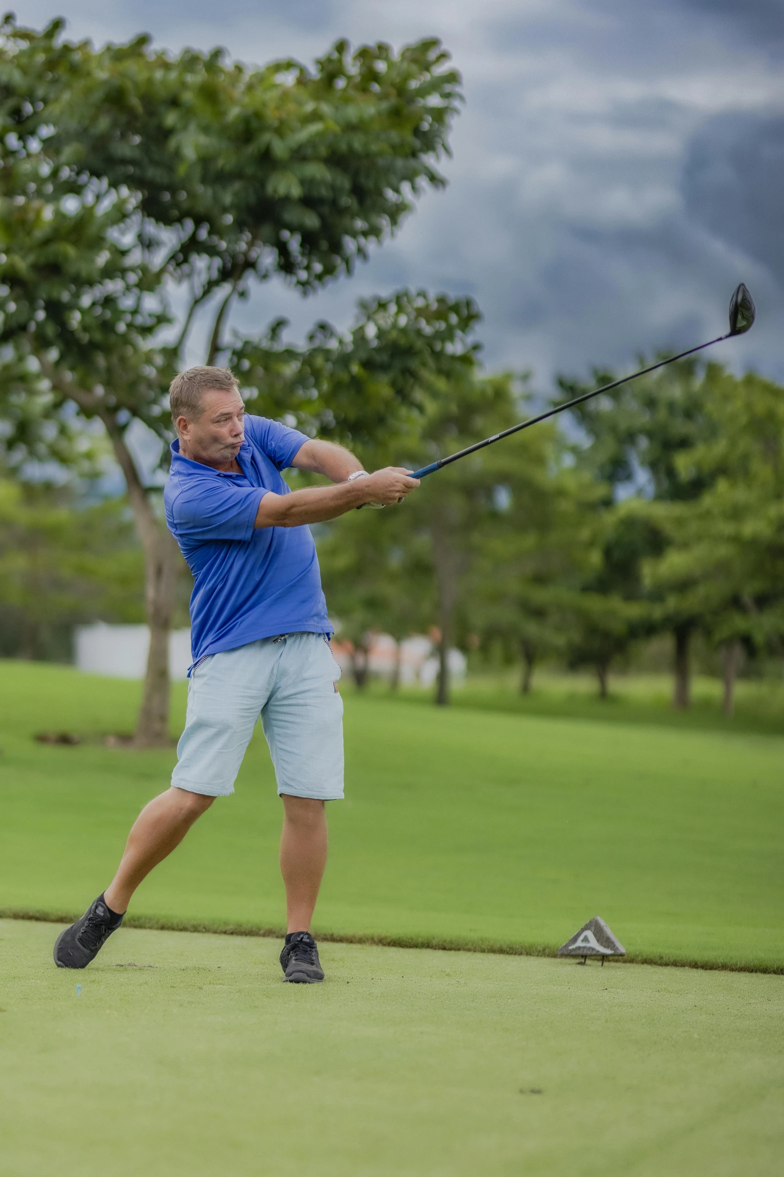 a man swinging a golf club at a golf course, by Arnie Swekel, happening, thailand, square, thumbnail, seasonal