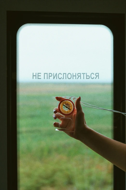 a woman holding an orange in front of a window, an album cover, inspired by Igor Grabar, unsplash, neo-romanticism, 000 — википедия, drinking a beer at train station, in field high resolution, hgrenades