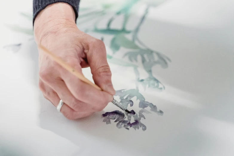 a close up of a person painting with a brush, an airbrush painting, inspired by Quentin Blake, dragon paw art, bright white porcelain, botanical art, art with ai