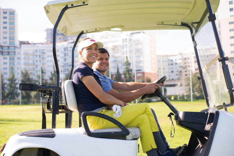 a man and a woman sitting in a golf cart, square, premium, hoang lap, high resolution image