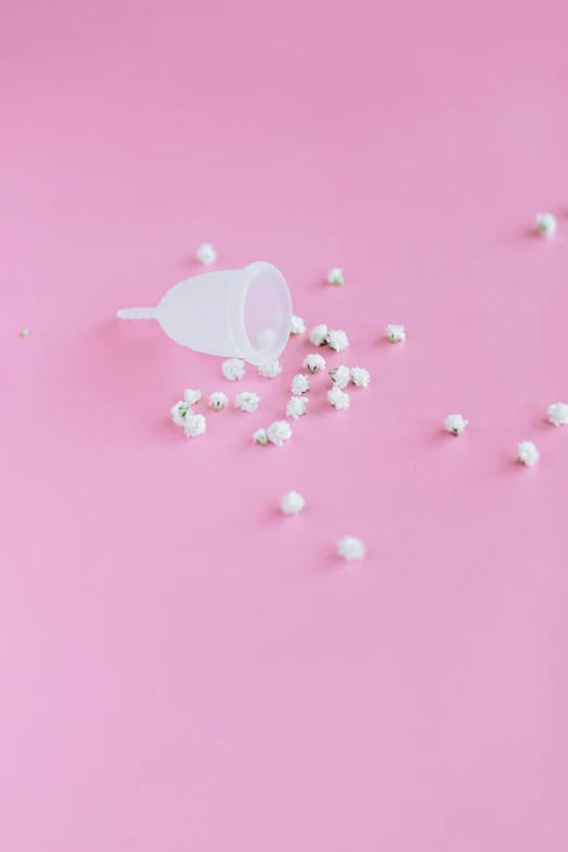 white pearls scattered on a pink surface, a cartoon, by Elsa Bleda, trending on unsplash, plasticien, surgical iv drip, seeds, pregnancy, milk