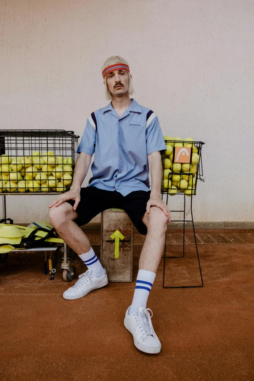 a man sitting on a bench with a tennis racket, by Nathalie Rattner, trending on dribble, pale blue outfit, official store photo, cargo shorts, juice