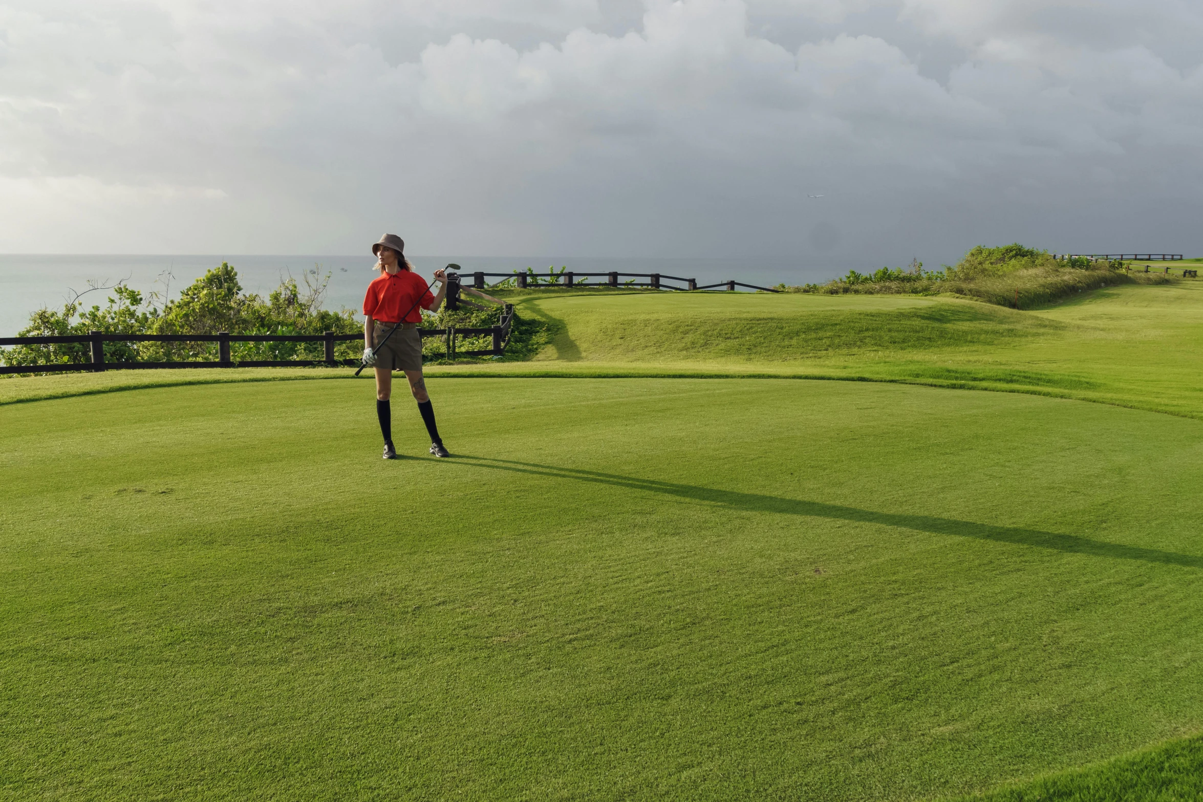 a woman standing on top of a green golf course, by Jesper Knudsen, happening, aruba, avatar image