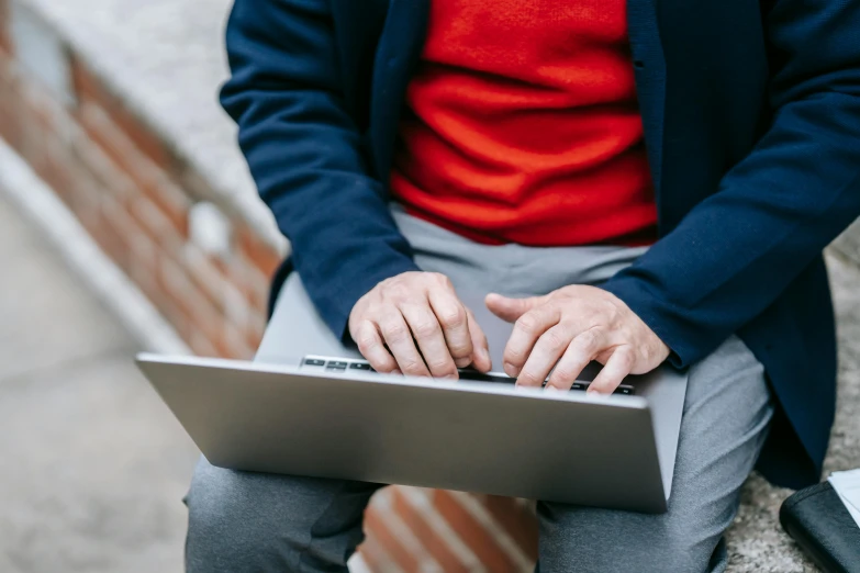 a close up of a person using a laptop, by Carey Morris, red and grey only, middle - age, in an urban setting, lachlan bailey