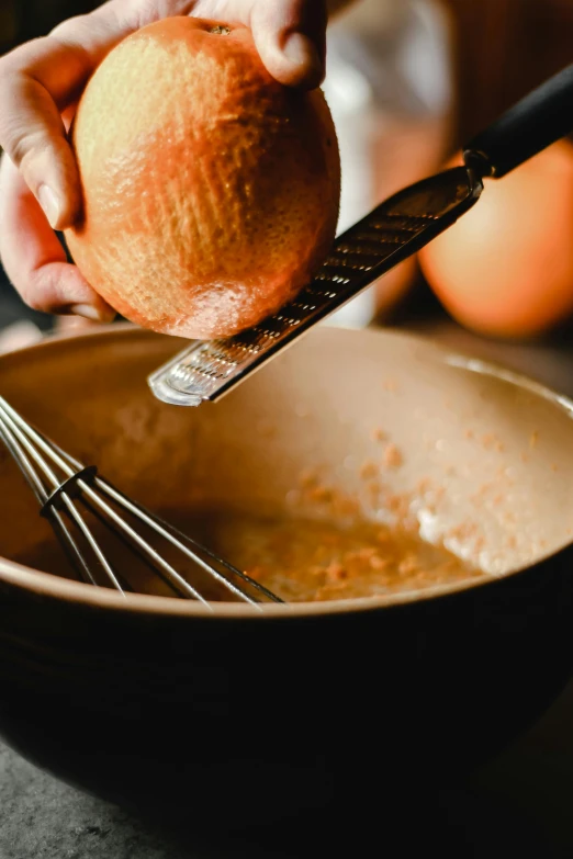 a person squeezing an apple with a whisk in a bowl, orange, wet clay, thumbnail, pots and pans