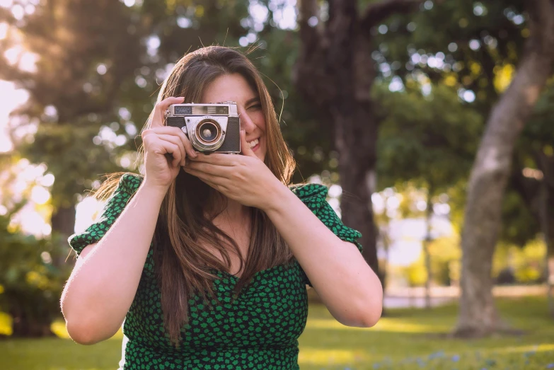 a woman taking a picture with a camera, a picture, pexels contest winner, green, in retro colors, lovingly looking at camera, youtube thumbnail