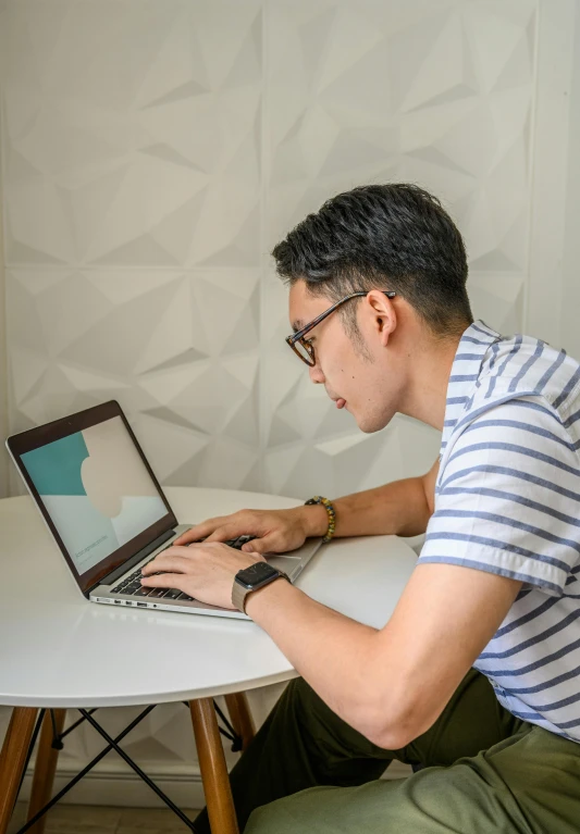 a man sitting at a table using a laptop computer, profile image, darren quach, rectangle, high quality image