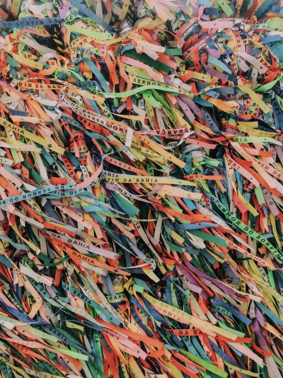 a pile of colorful ribbons sitting on top of a table, an album cover, by Howardena Pindell, unsplash, low detail, shredded, imaginary slice of life, colored woodcut